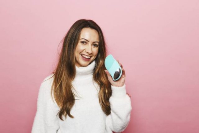 women holding a face care product